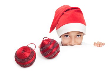 Boy in christmas red hat holding red decorative balls clipart