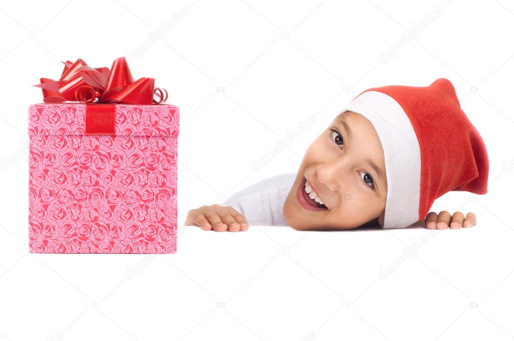 Boy in christmas red hat holding a gift box