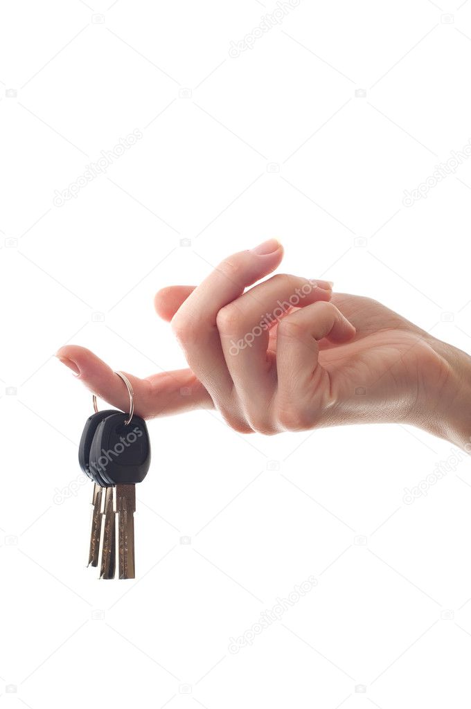 Realtor female hand holding door key to new house or flat isolated on white