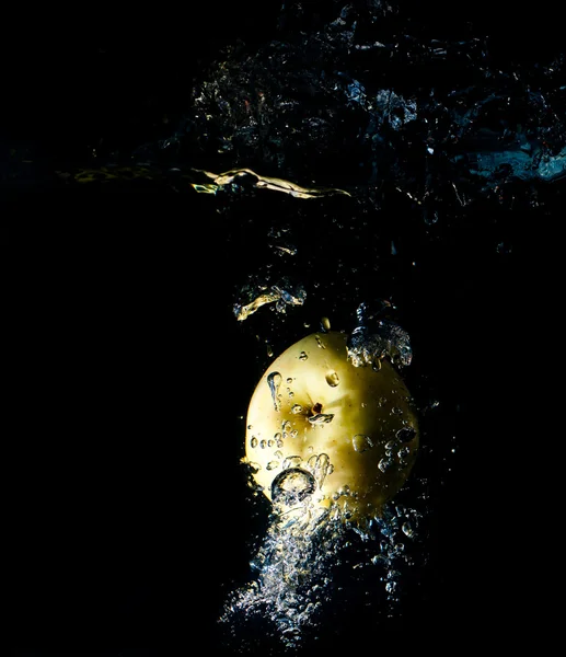Yellow apple in water splash — Stock Photo, Image