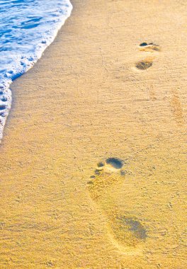 Footprint on sand with foam