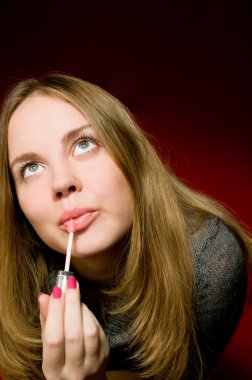 Model getting lipstick applied.