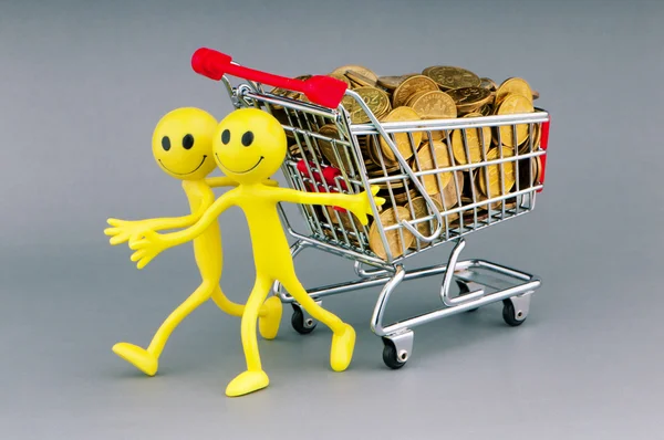 Smilies with shopping carts and coins — Stock Photo, Image