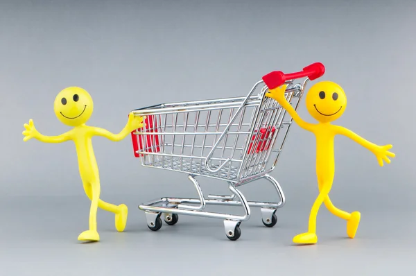 Shopping cart and happy smilies Stock Image
