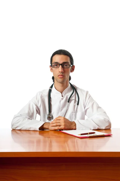 Doctor sitting at the desk on white — Stock Photo, Image