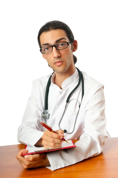 Läkare som sitter vid skrivbordet på vit — Stockfoto