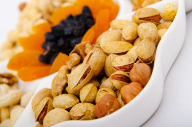 Nut selection served in the plate clipart