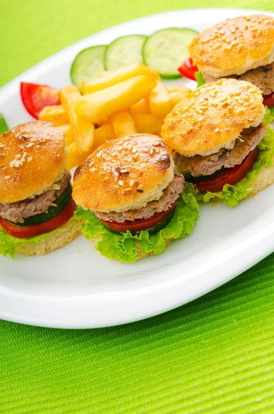 Plate with tasty mini burgers — Stock Photo, Image
