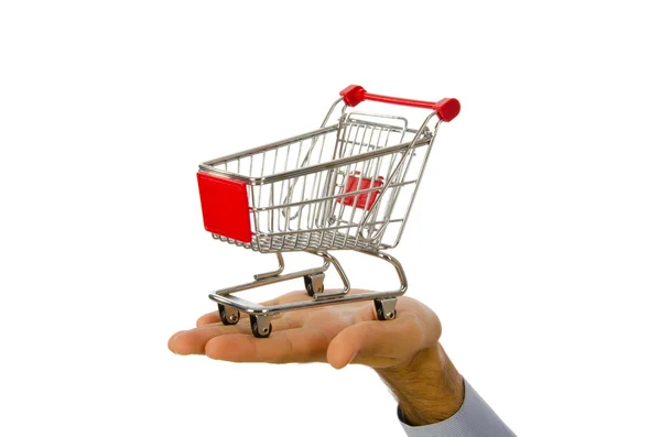 Mão segurando carrinho de compras no branco — Fotografia de Stock