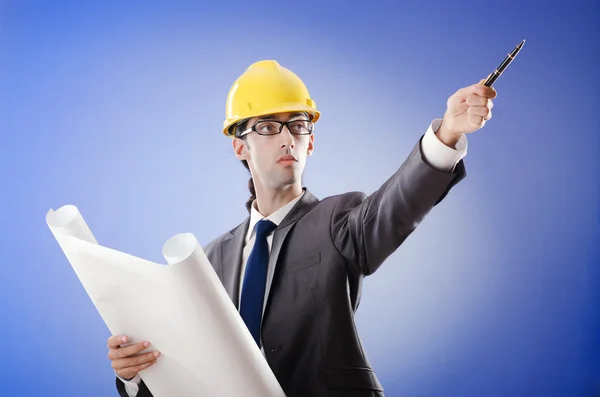 Young architect with drawings and hardhat — Stock Photo, Image