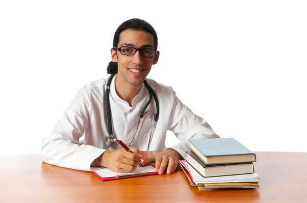 Dottore seduto alla scrivania su bianco — Foto Stock