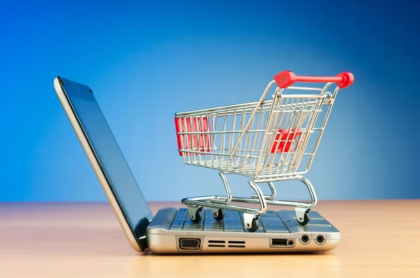 Internet online shopping concept with computer and cart Royalty Free Stock Images