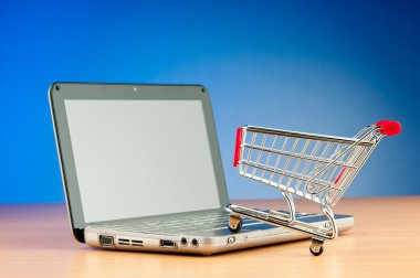 Internet online shopping concept with computer and cart clipart