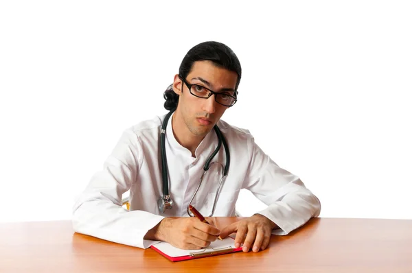 Доктор сидит за столом на белом — стоковое фото