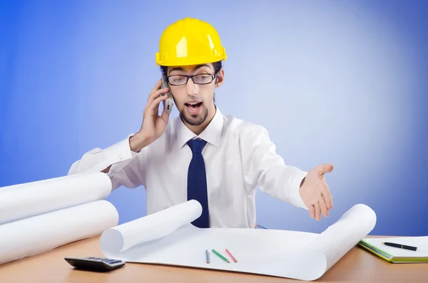 Young engineer looking at drawings — Stock Photo, Image
