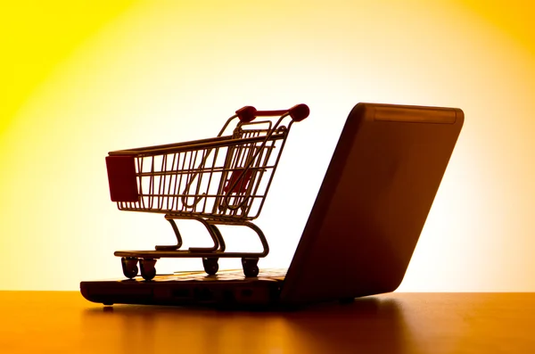 Silhoette of shopping cart and laptop — Stock Photo, Image