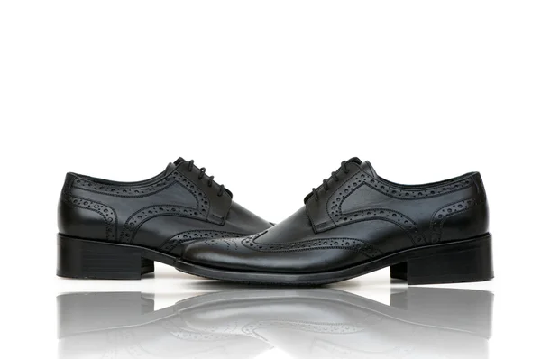 Fashion concept met mannelijke schoenen op wit — Stockfoto