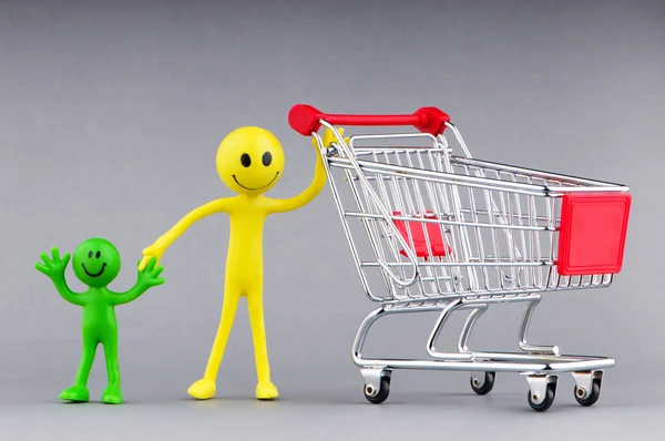 Shopping cart and happy smilies Royalty Free Stock Images
