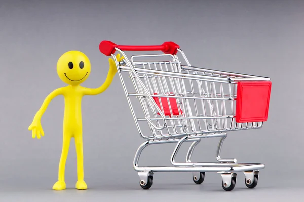 Shopping cart and happy smilies Royalty Free Stock Photos