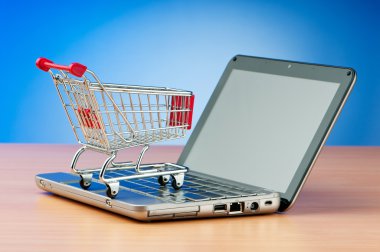 Internet online shopping concept with computer and cart clipart