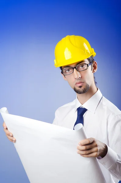 Young engineer looking at drawings — Stock Photo, Image