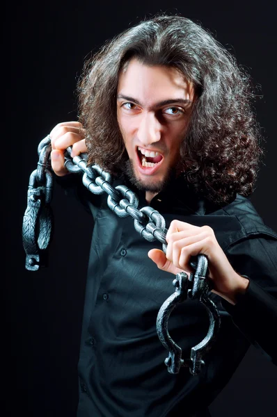 Man chained in the dark room — Stock Photo, Image