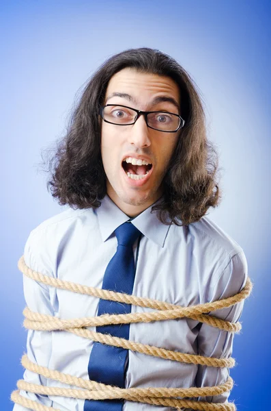 Jovem empresário amarrado com corda — Fotografia de Stock