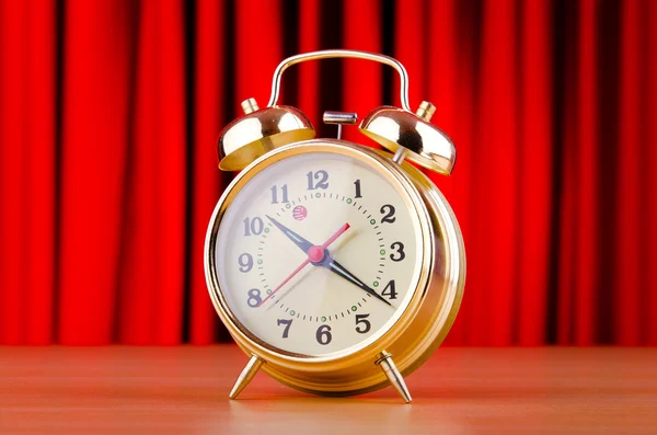Alarm clock against curtain — Stok fotoğraf