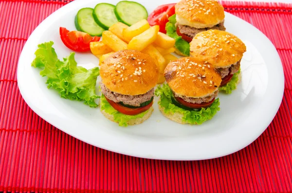 Plate with tasty mini burgers — Stock Photo, Image