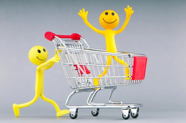 Shopping cart and happy smilies — Stock Photo, Image