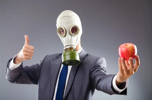 Επιχειρηματίας με μάσκα αερίων και μήλο — Φωτογραφία Αρχείου