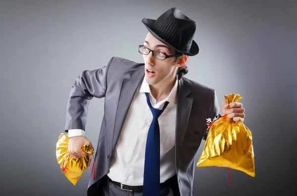 Businessman with sacks of presents — Stock Photo, Image