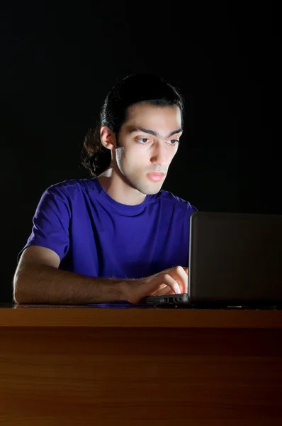 Hacker sitting in dark room — Stock Photo, Image