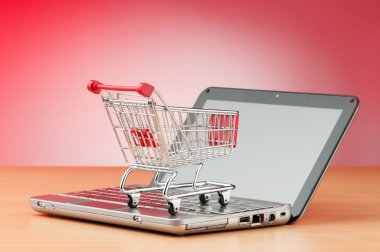 Internet online shopping concept with computer and cart clipart