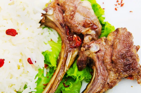 Lamb ribs with rice served in the plate — Stock Photo, Image