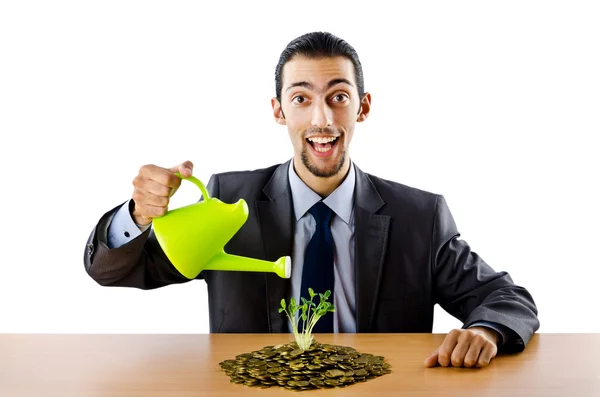 Businessman with gold seedlings and coins — Stock Photo, Image