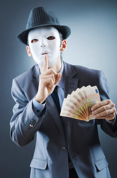 Бизнесмен с деньгами и маской — стоковое фото