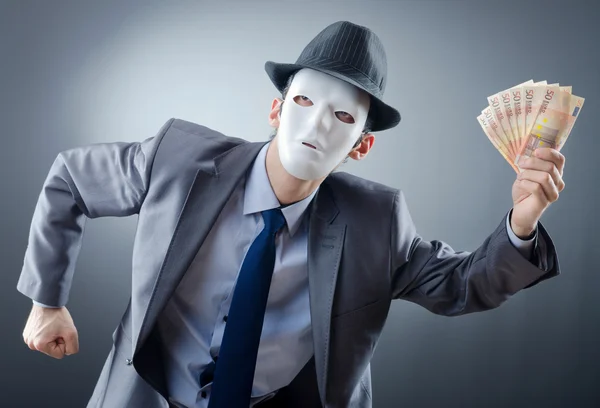 Businessman with money and mask — Stock Photo, Image
