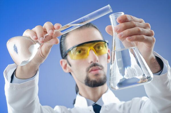 Young chemist student working in lab