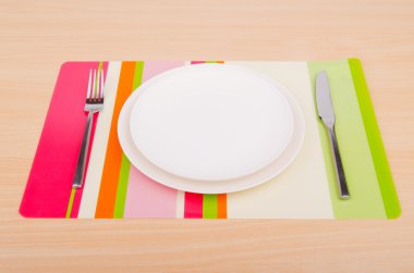 Emtpy plates with utensils on table clipart