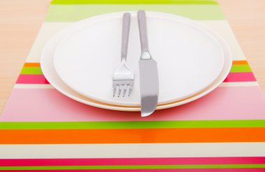 Emtpy plates with utensils on table clipart