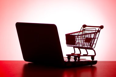 Silhoette of shopping cart and laptop clipart