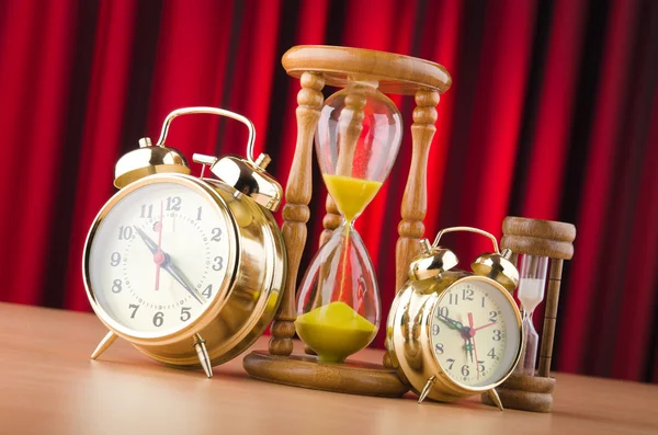 Alarm clocks and hourglass in time concept — Stock Photo, Image