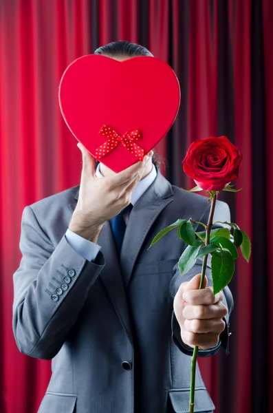 Young man with red rose — Stock Photo, Image