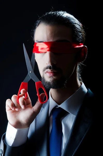 Man cutting ribbon on his eyes — Stock Photo, Image