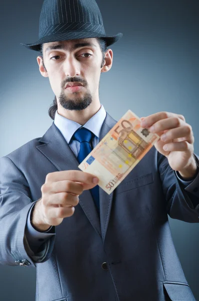 Detective looking at fake money — Stock Photo, Image