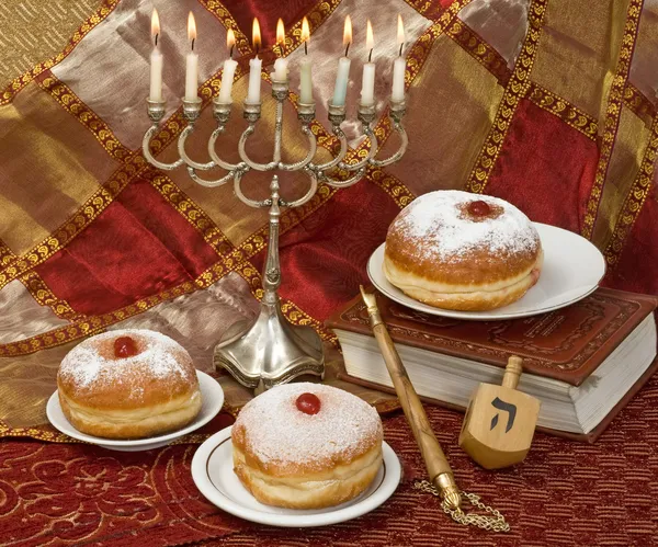 Hanukkah menorah with dreidel and doughnuts — Stock Photo, Image