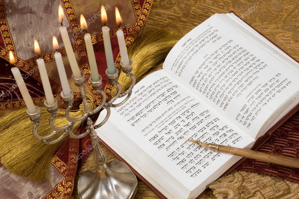 Hanukkah menorah with candles and torah