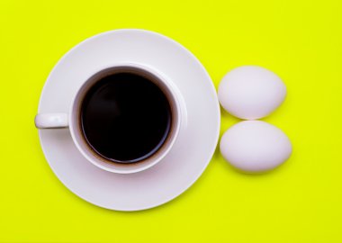 Cup of cofee and eggs for breakfast clipart