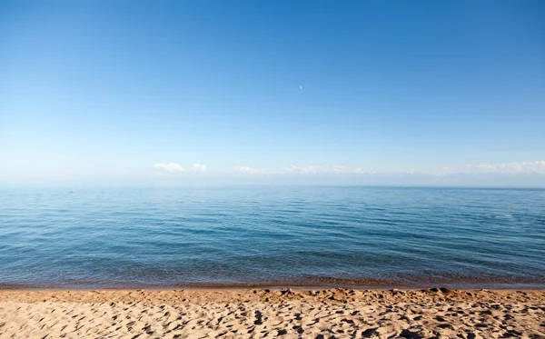 stock image Calm blue Lake Issyk-Kul with beach